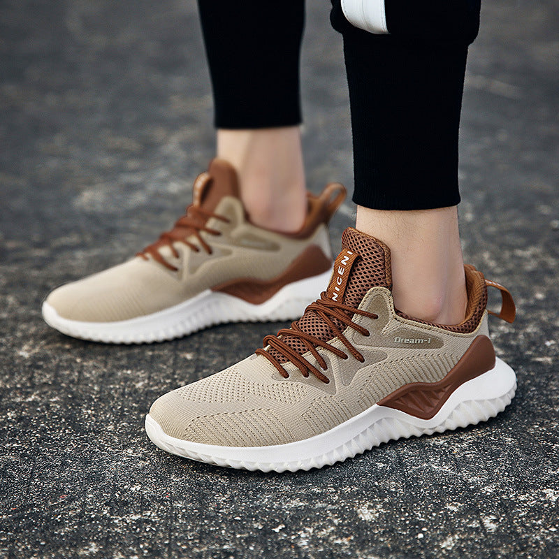 Beige and brown sneakers worn on a dark asphalt surface