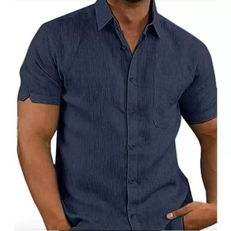 Navy blue short-sleeve shirt worn by a person on a white background