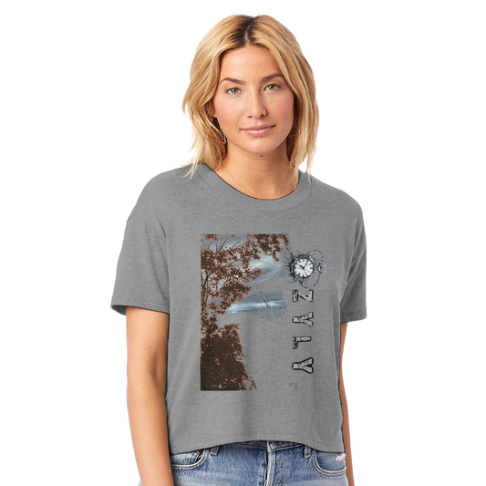 Woman wearing a gray t-shirt with a tree graphic design with ''OZYLY'' and clock watch